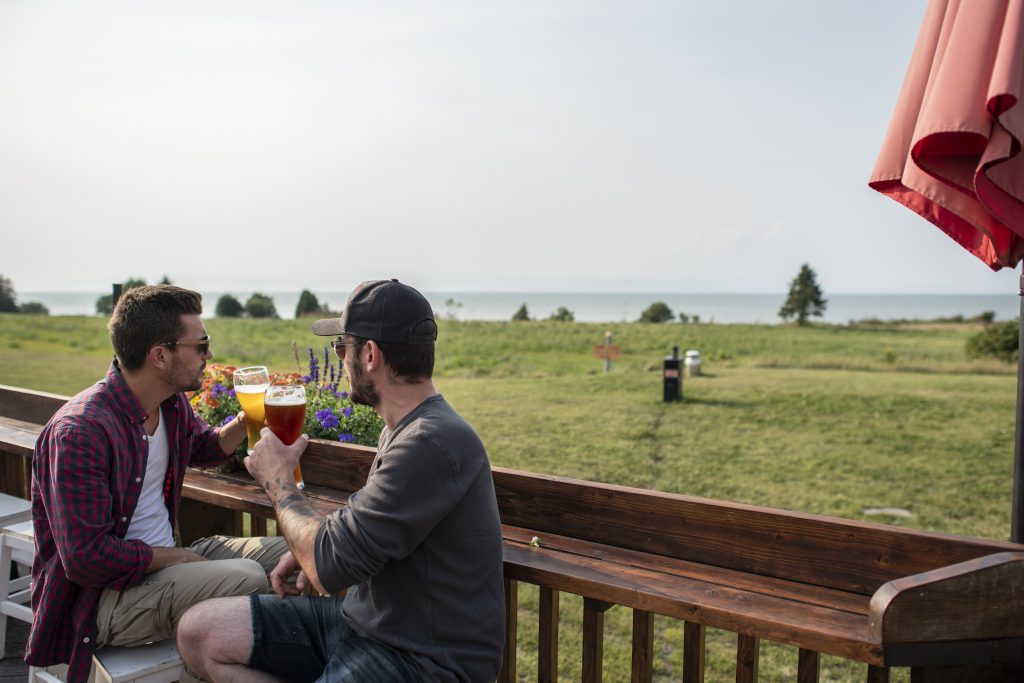Two people drinking a beer and enjoying the view
