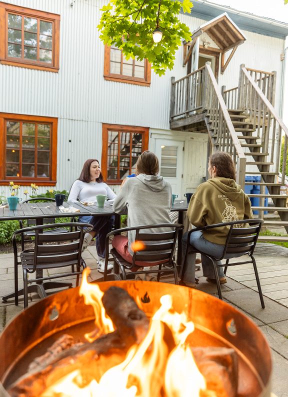 Rivière du Loup hostel, campfire, people at a table
