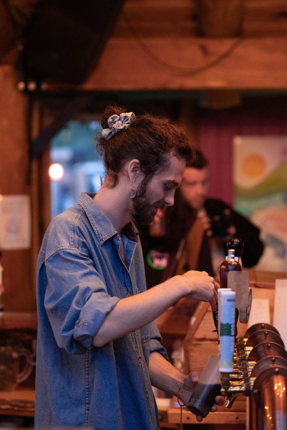 Someone serving a beer at the bar