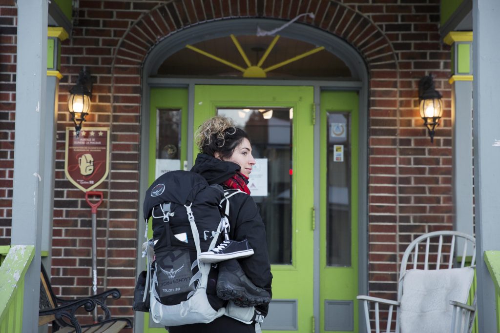 Traveler in front of the La Malbaie Hostel