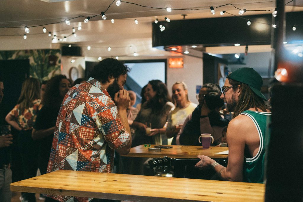 Group of travelers at the bar of the hostel