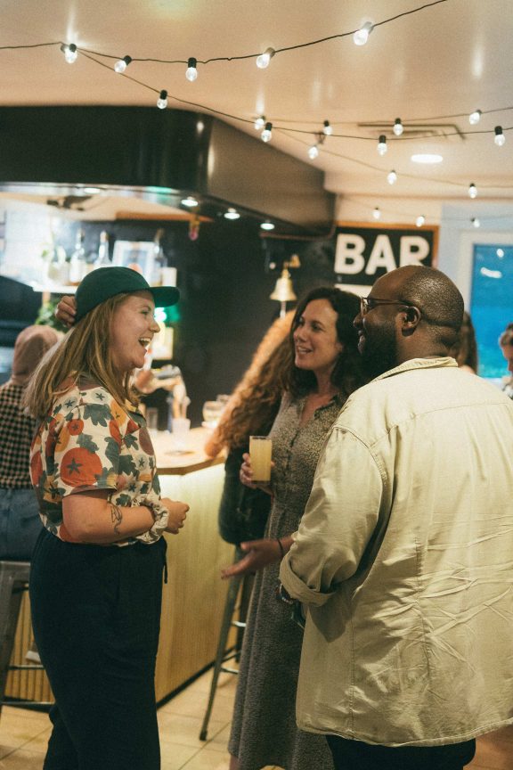 Three travelers at the hostel bar