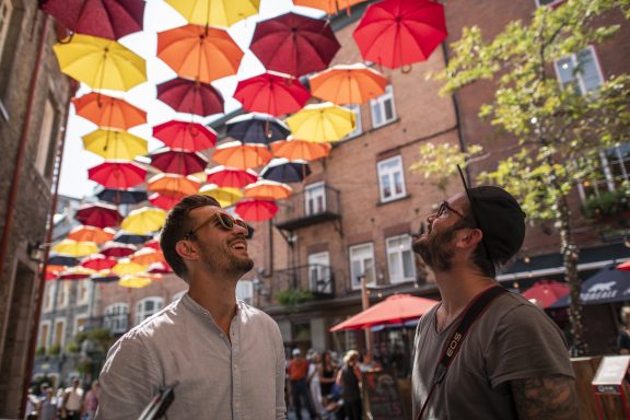 Two men under umbrellas