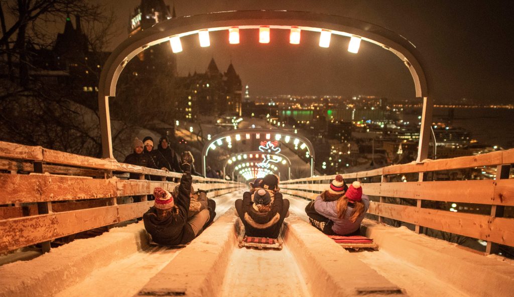 People going down the Dufferin Slides in Québec at night