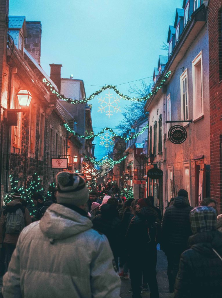People walking at night in a cozy street in Old Quebec