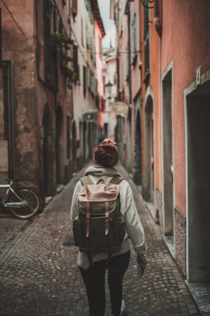A person walking in an alley from the back