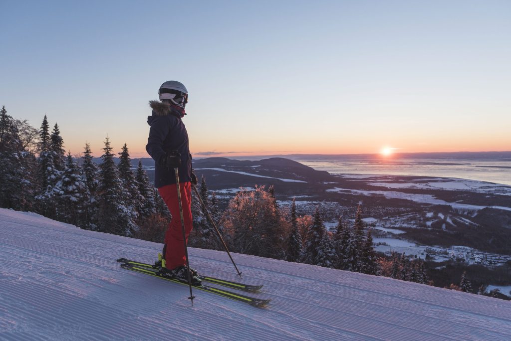 Woman in front of the sunset at at Mont Ste-Anne