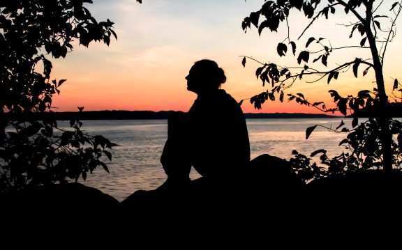 woman lake quebec sunset