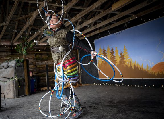 Young Aboriginal woman performing with hoops