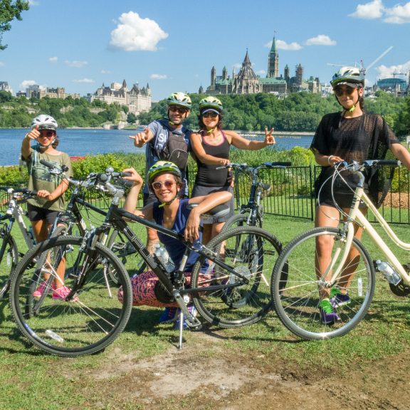 Group of people on rental bikes from Escape Bicycle in front of the parliament.